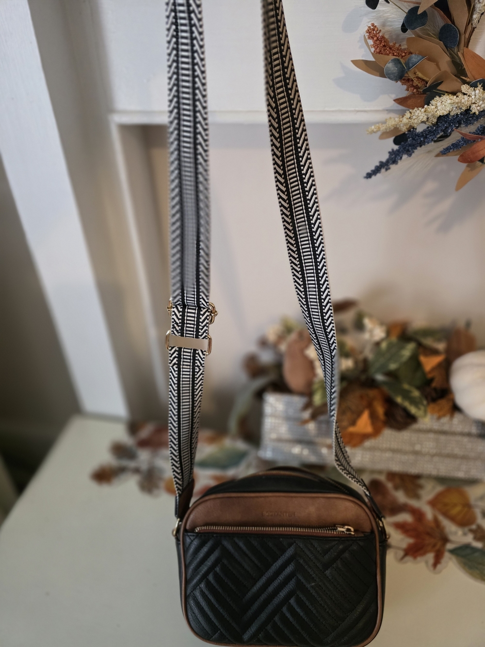 Quilted Black and Brown Crossbody Bag with Patterned Strap